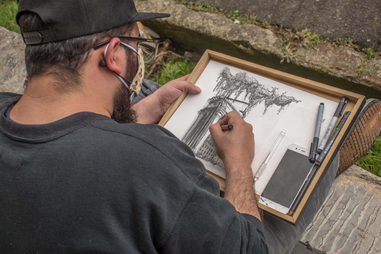 Hombre dibujando durante la dibujaton de columbarios