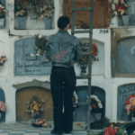 Mujer visitando una tumba y llevando flores en el antiguo Cementerio de pobres en los años 90